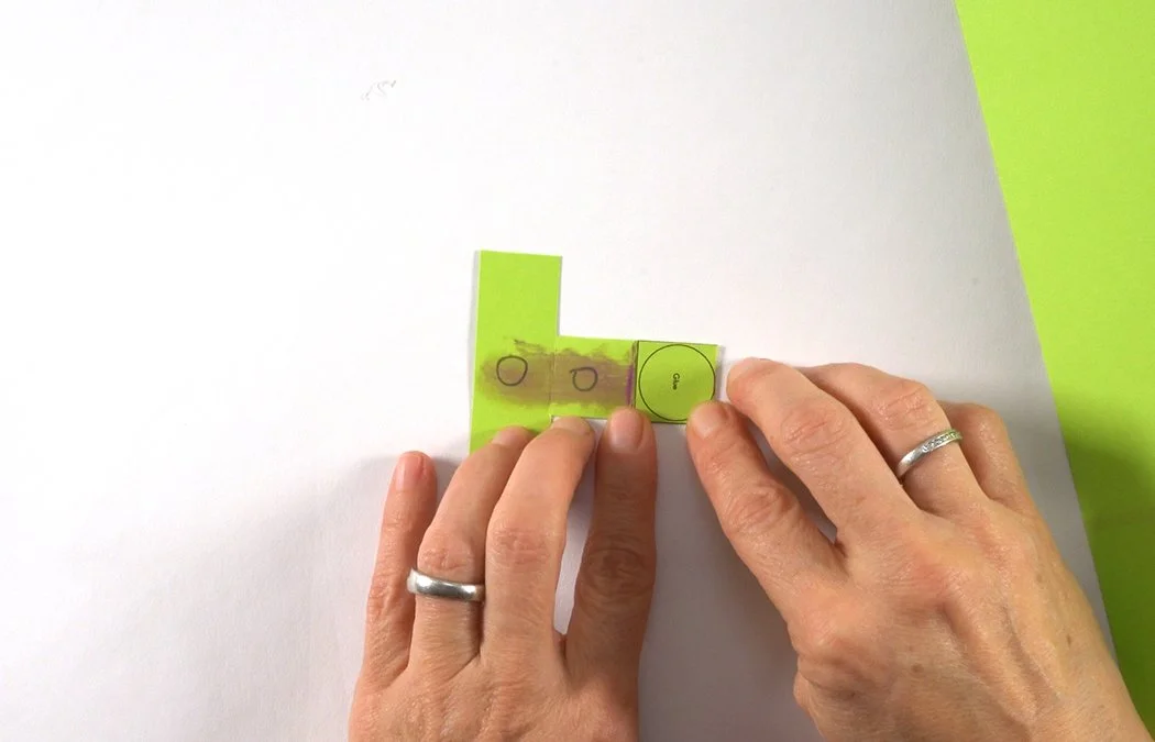 Fold the end over to glue one X panel to the other X panel.