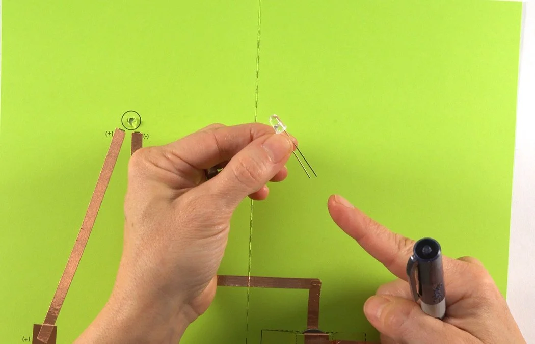 Get an LED light. The longer wire lead is (+).