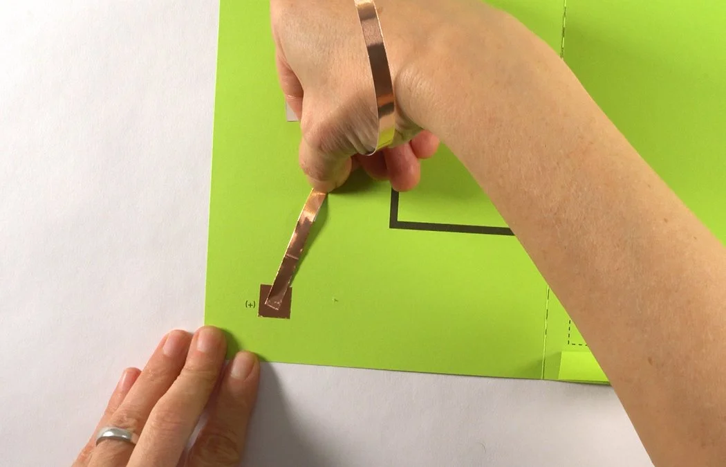 Place the copper directly over the square copper pad on the left corner of the card.