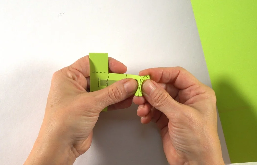 Fold the end into a peak on the solid dashed line.