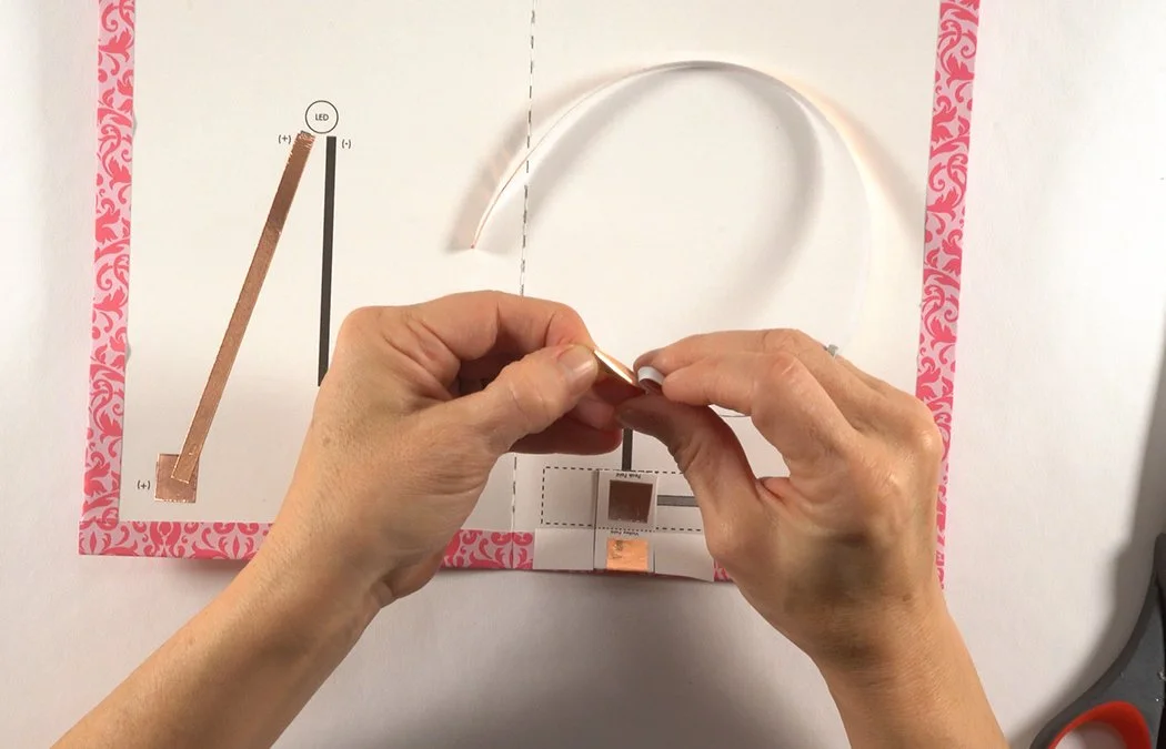 Get another piece of 1/4" copper tape. Remove a bit of backing.