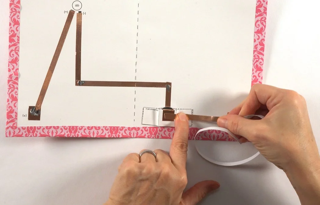 Get a 1/4" copper strip. Remove a bit of backing and stick it to the copper on the outside of the battery pocket.
