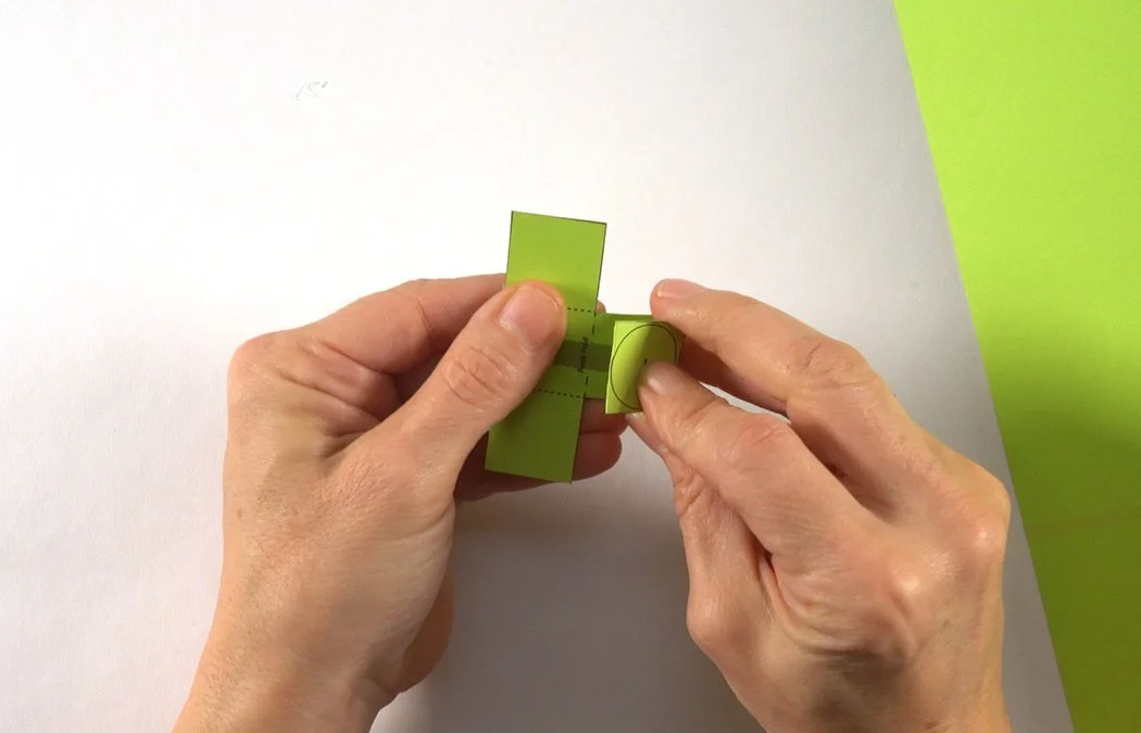 Fold the center dashed line into a valley shape.