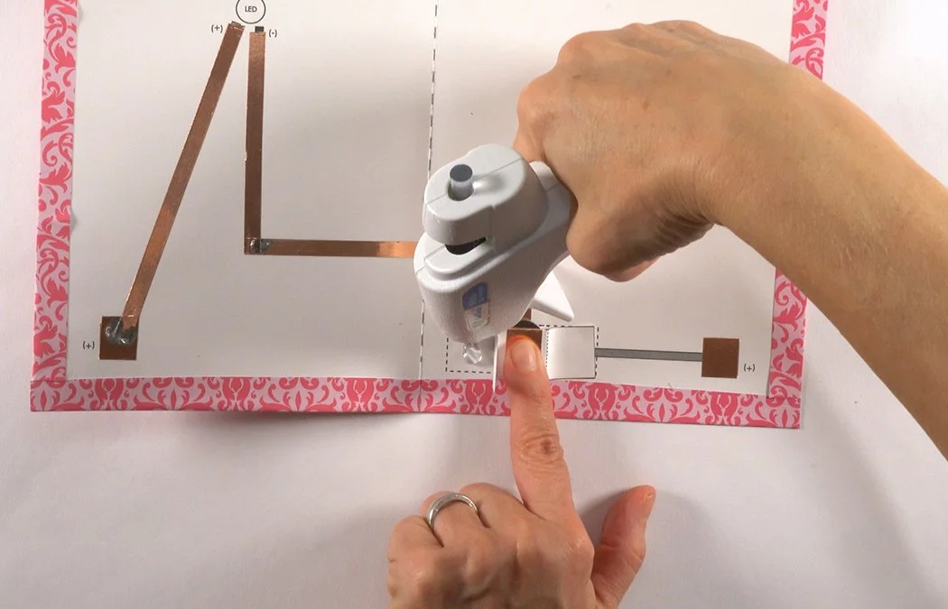 Lift the other tab and add hot glue.