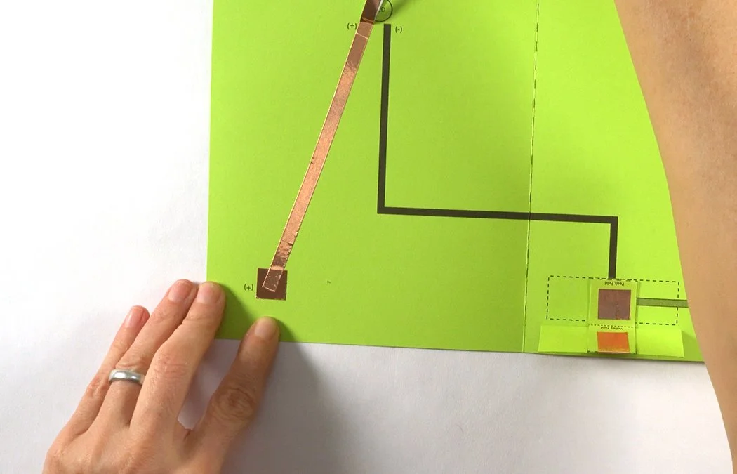 Remove a bit of backing at a time and place the copper over the grey (+) line.