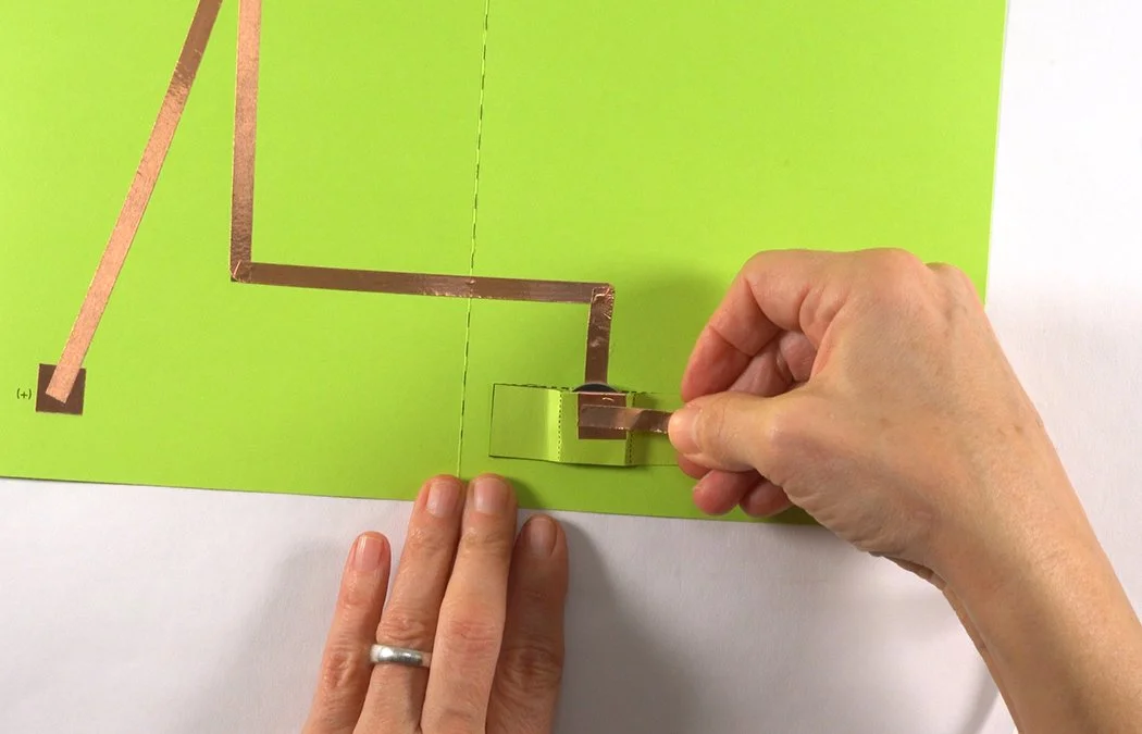 Get a strip of 1/4" copper tape. Remove a bit of backing and stick it to the copper on the outside of the battery box.