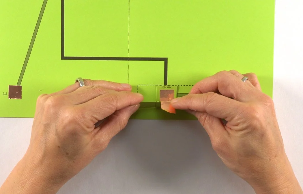 Wrap the copper rectangle over the edge of the battery box.