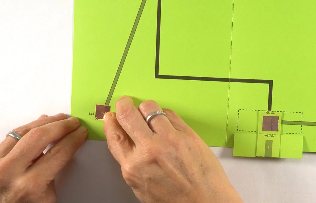Place another 1/2" x 1/2" copper tape square on the left corner square diagram.