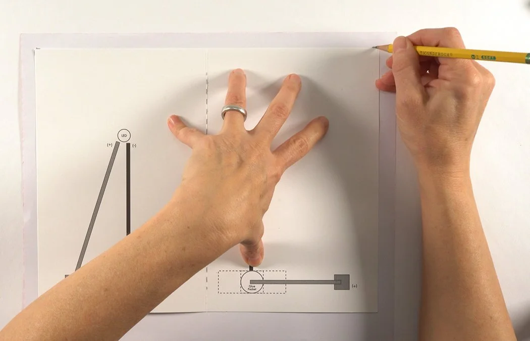 Place your template onto the back of your scrapbook paper. Mark the corners to get about a 1/2" boarder.