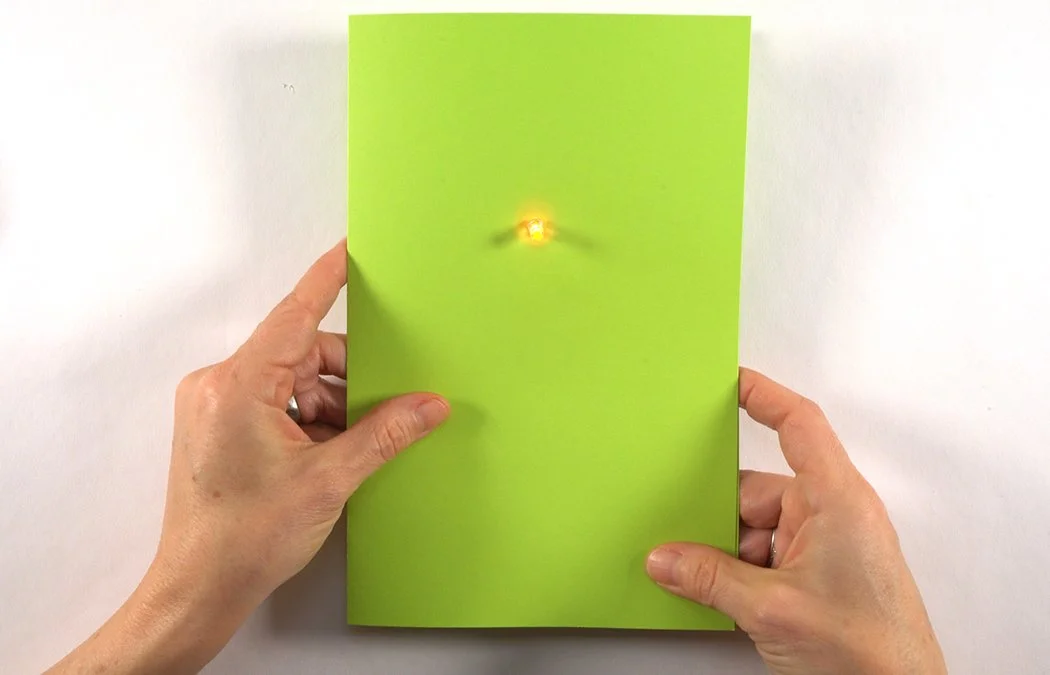 Close the card and press the right corner to connect the switch pads. Decorate with marker, paper and decorative items.