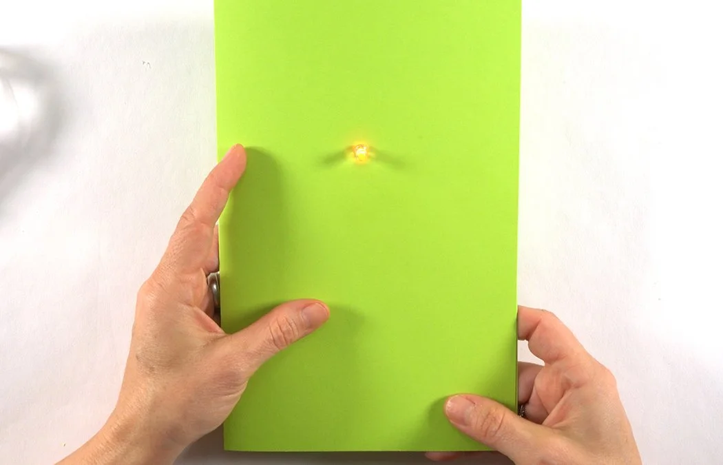 Close your card and press the right corner copper pads together test the light. If it does not turn on, squeeze your battery box, too. (A loose battery box is the most common reason a light won't work.)