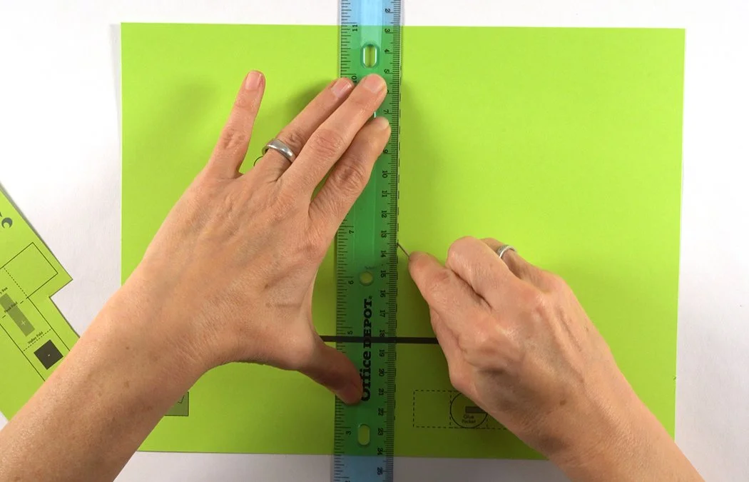 You can score the center line of the card with a ruler and embroidery needle to make a crispy fold. Line-up the ruler with the dashed line and run your needle down to indent the paper.