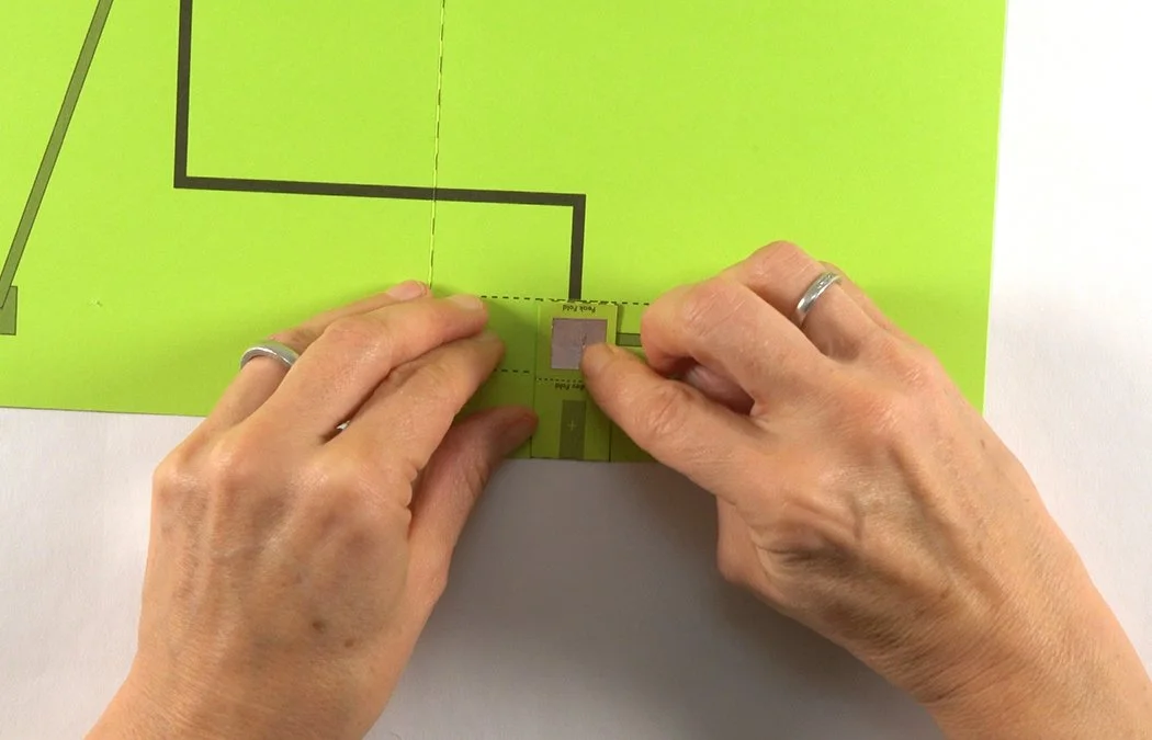Stick it to the black (-) square inside your battery box. The black diagrams are the (-) side of your circuit.