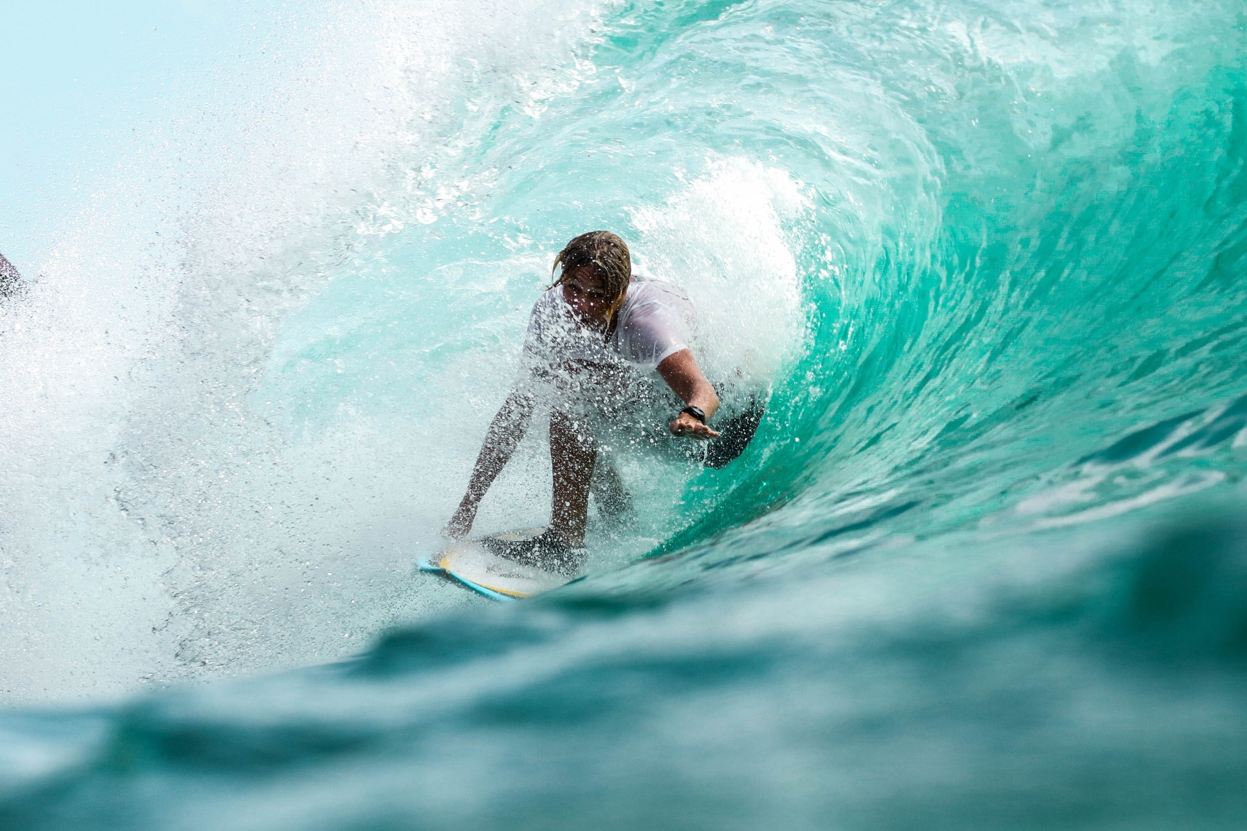 Surfer riding a large ocean wave, inside the barrel of the wave.
