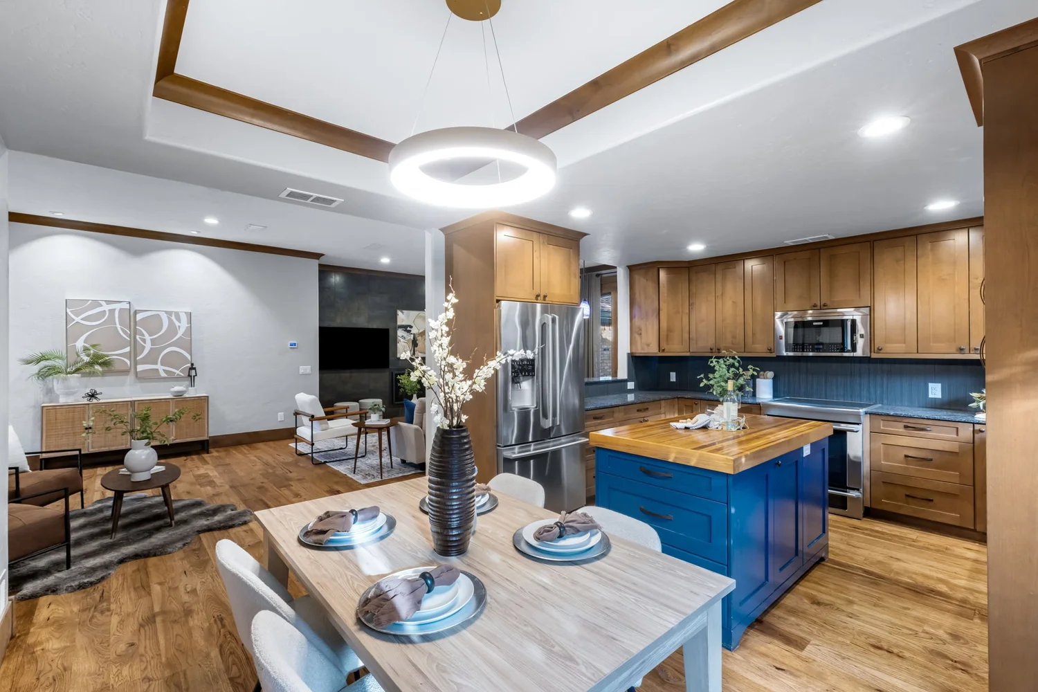 Kitchen with a blue island and warm wood cabinets