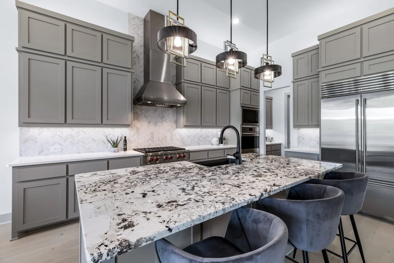 New build kitchen with gray cabinetry and pendants