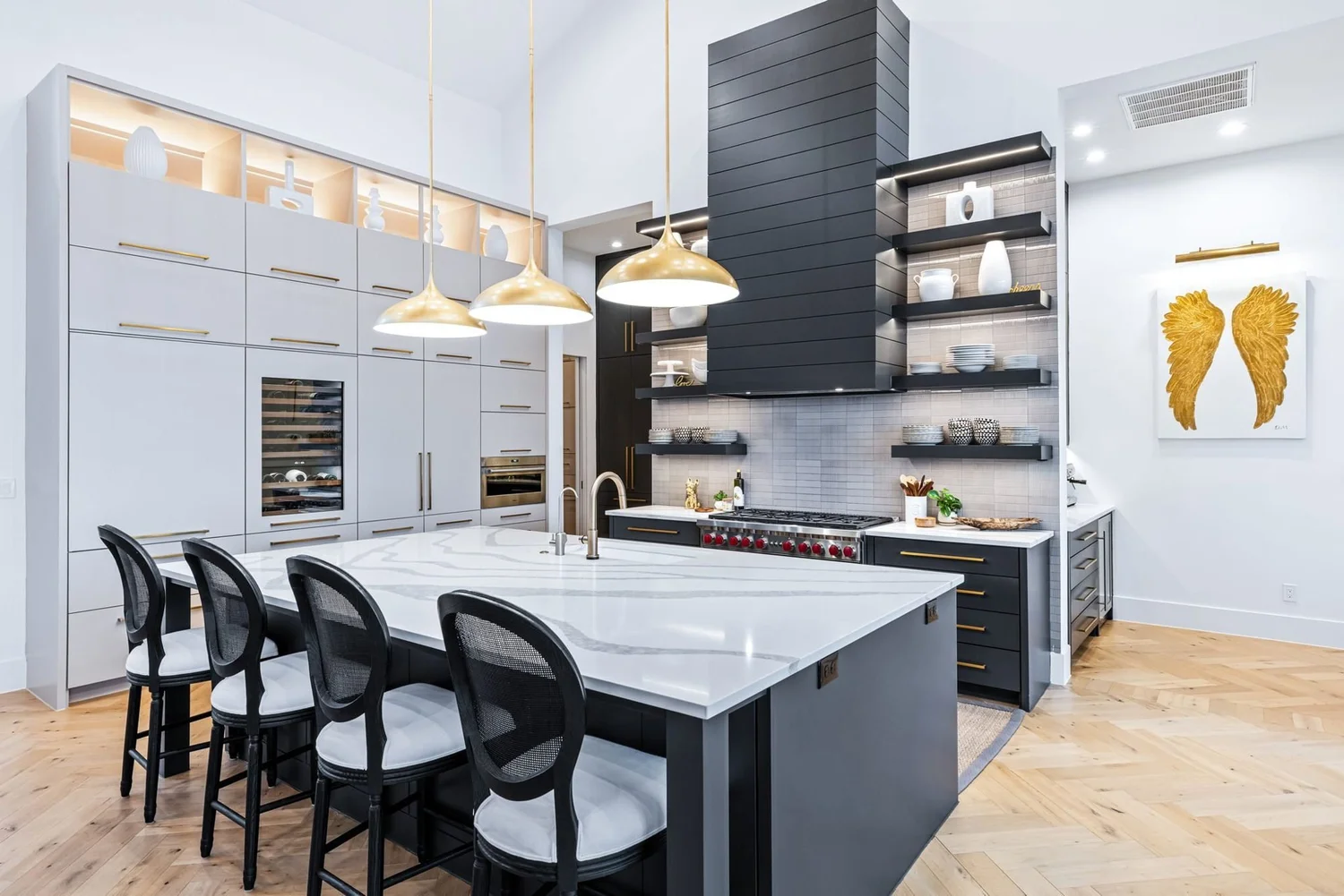 Lake house kitchen with black range wall and brass pendants