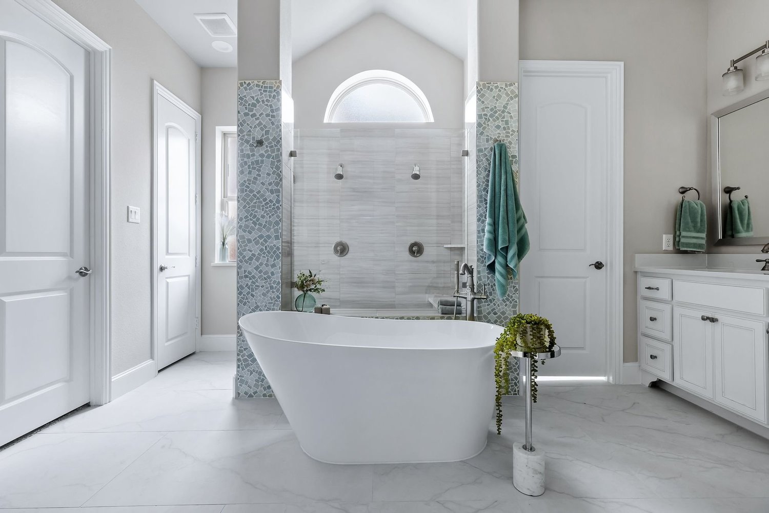 Primary bath with freestanding tub and arched window