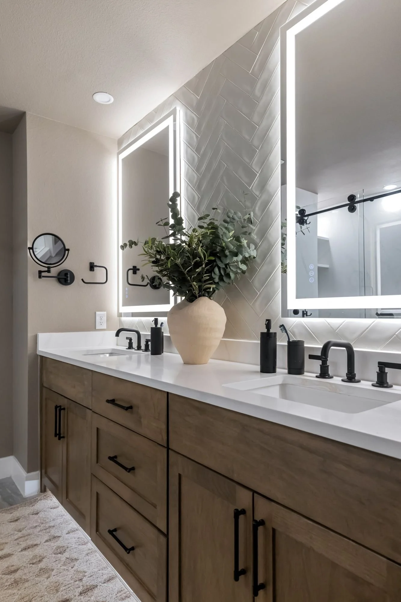 Wood double vanity with lit mirror and greenery