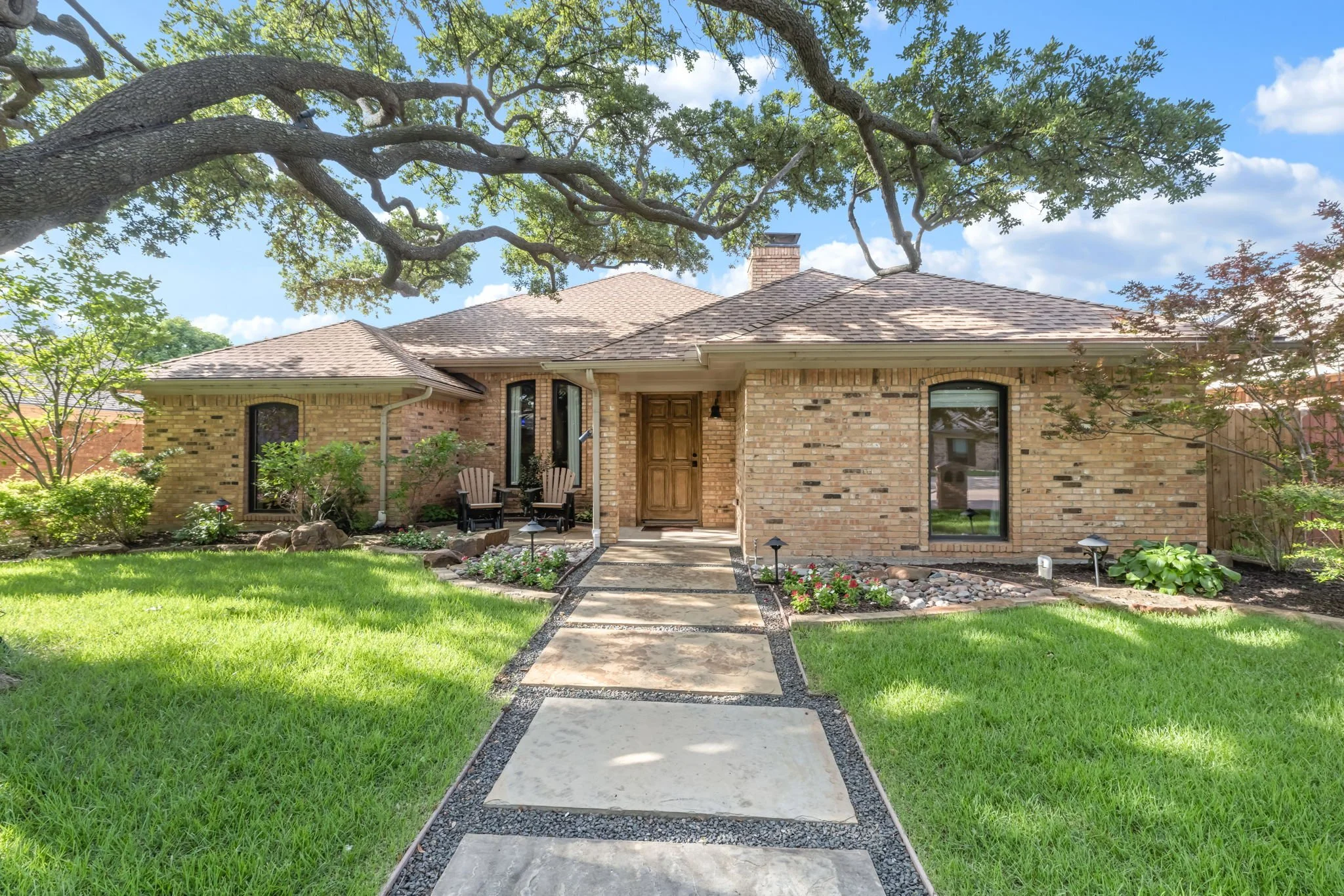 Brick home under a sprawling live oak