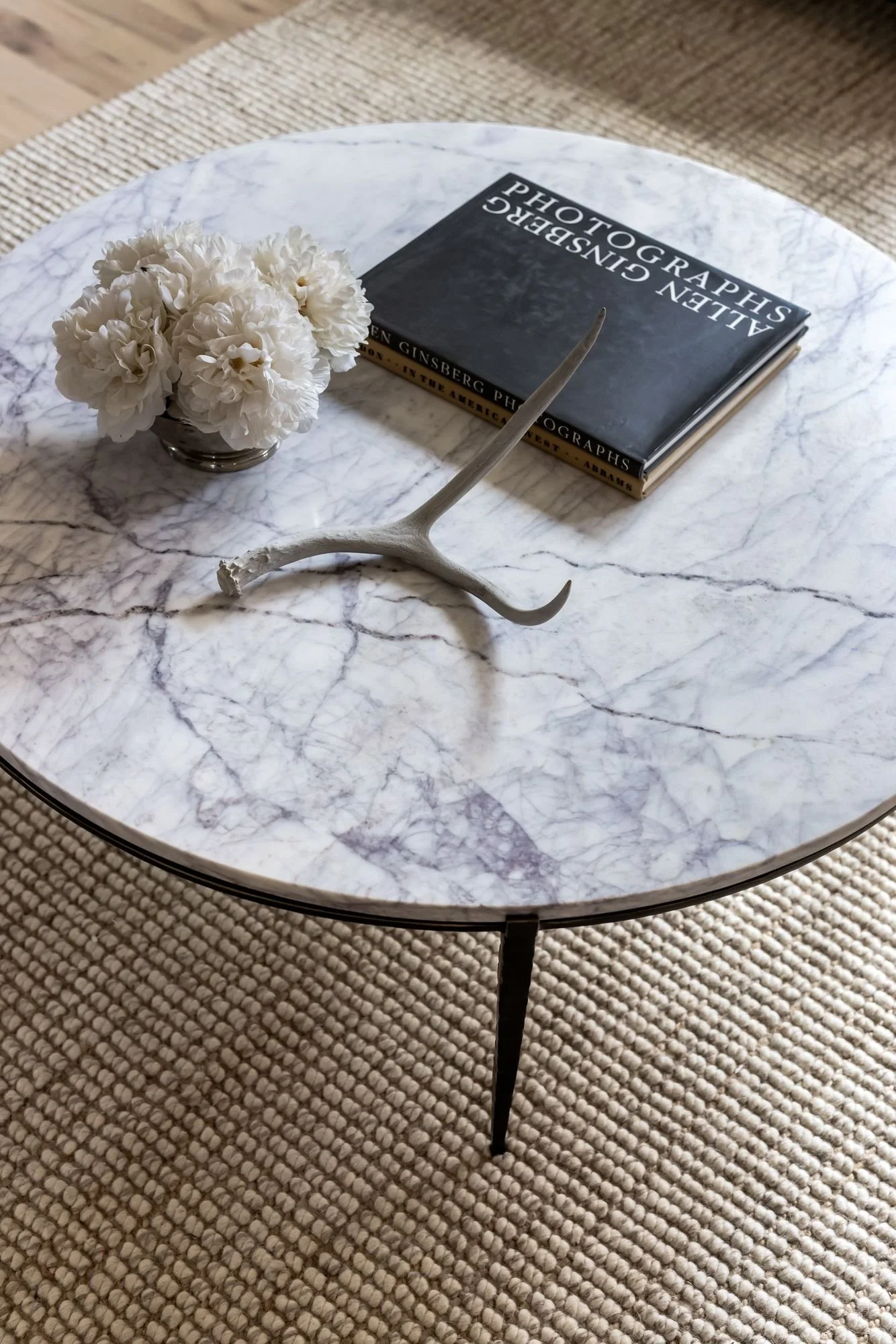 Detail of a marble coffee table with antler and books