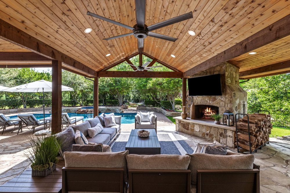 Covered outdoor living room with fireplace