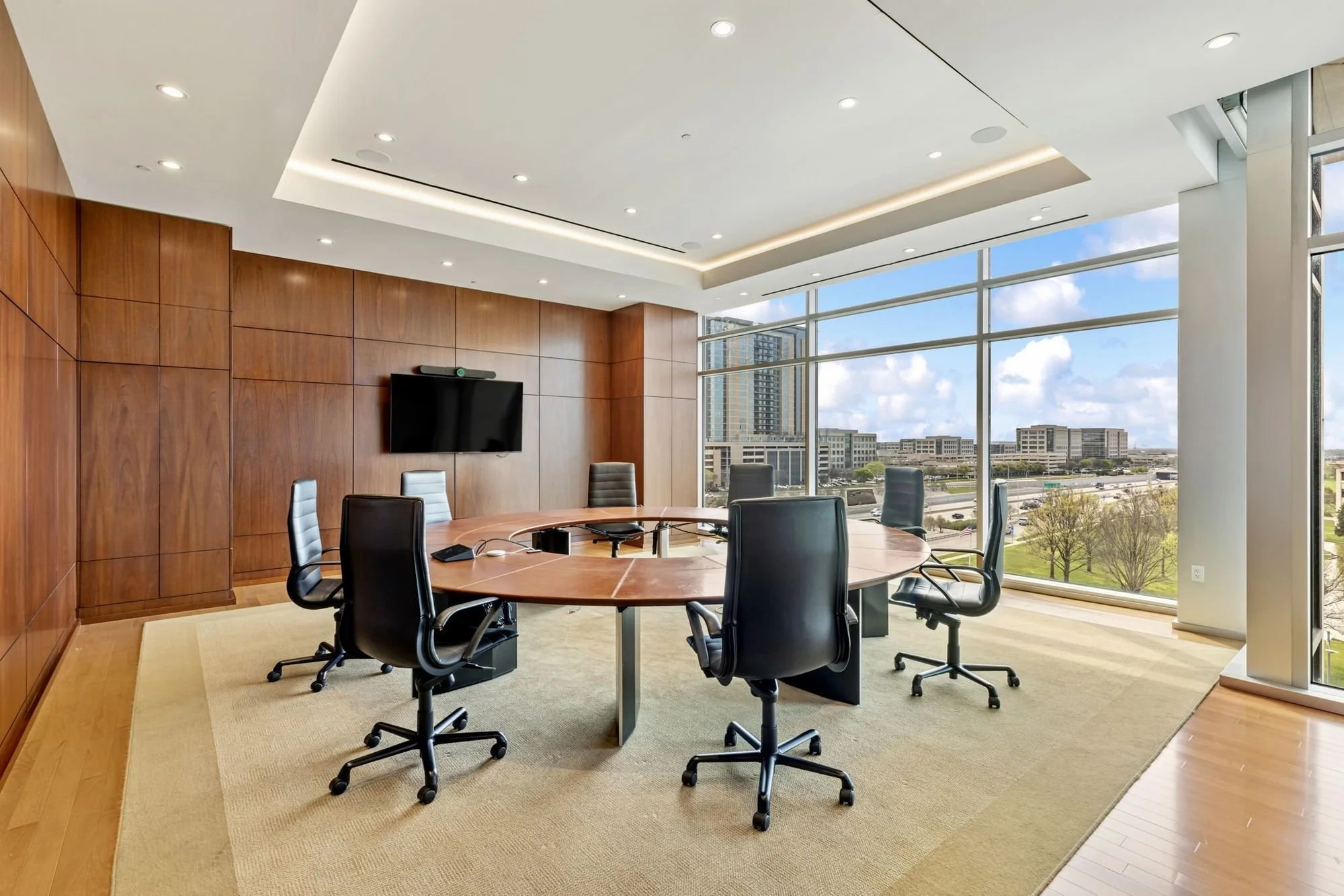 Walnut-paneled boardroom with city views