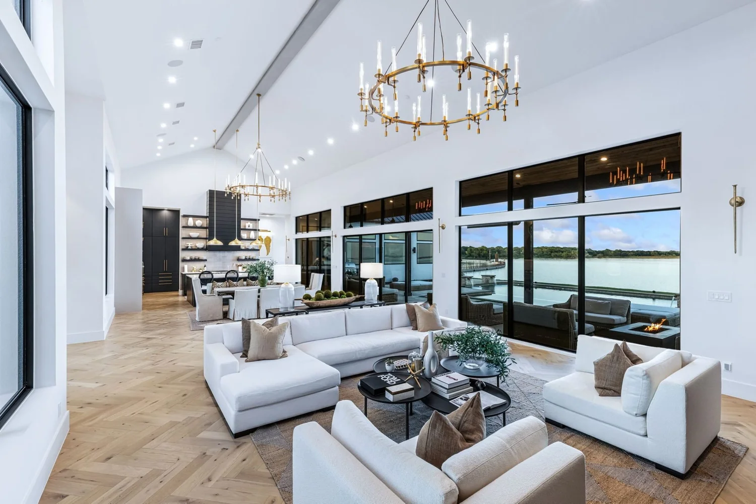 Lake house great room with chandeliers and lake views