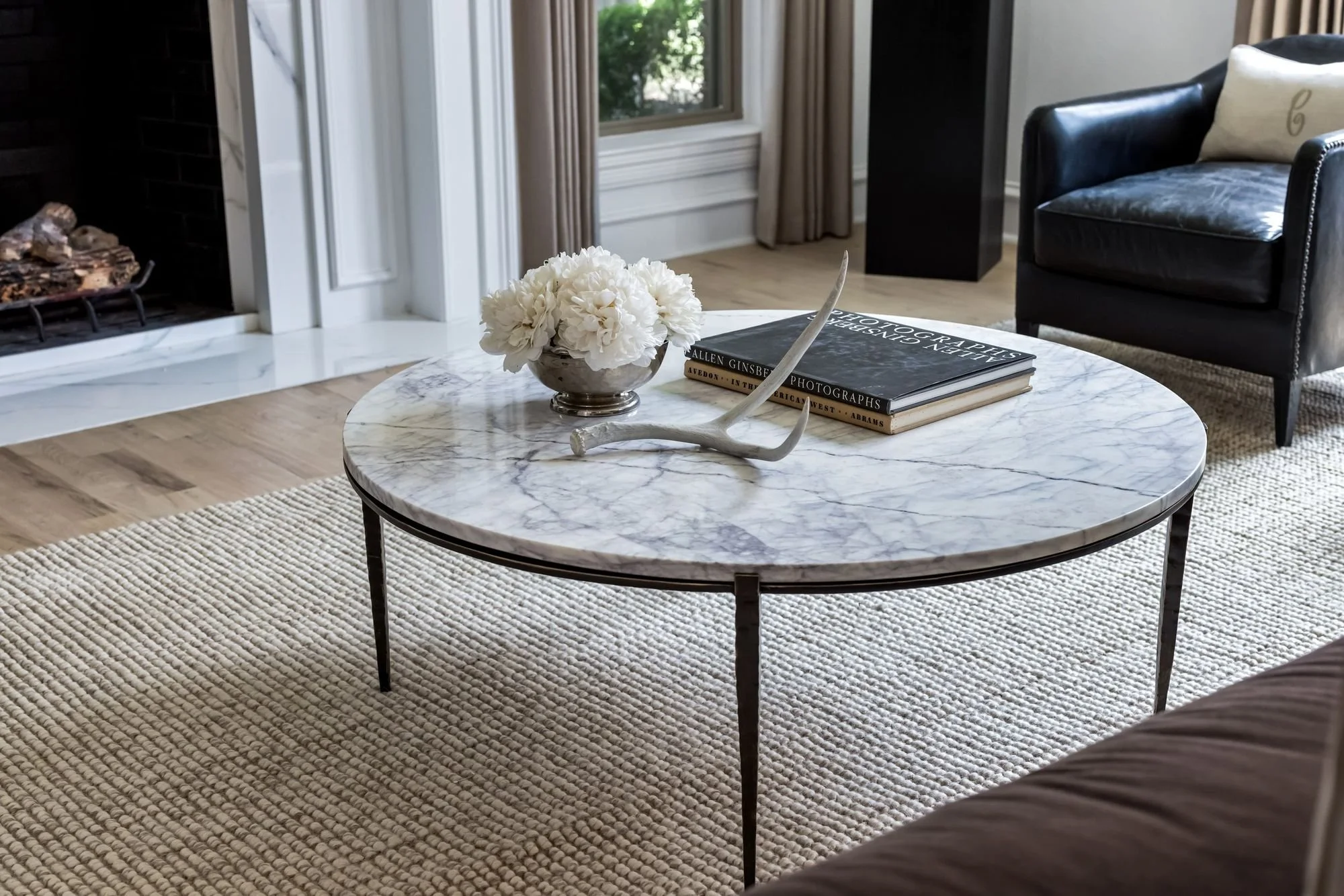 Marble coffee table with styled books in a calm neutral living room