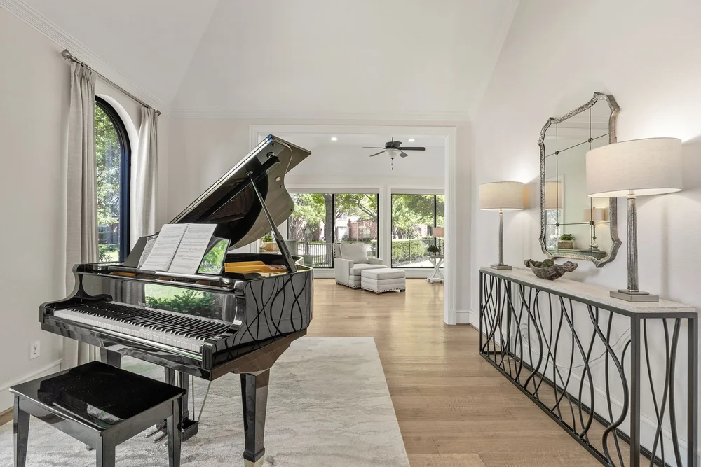 Piano room with arched window