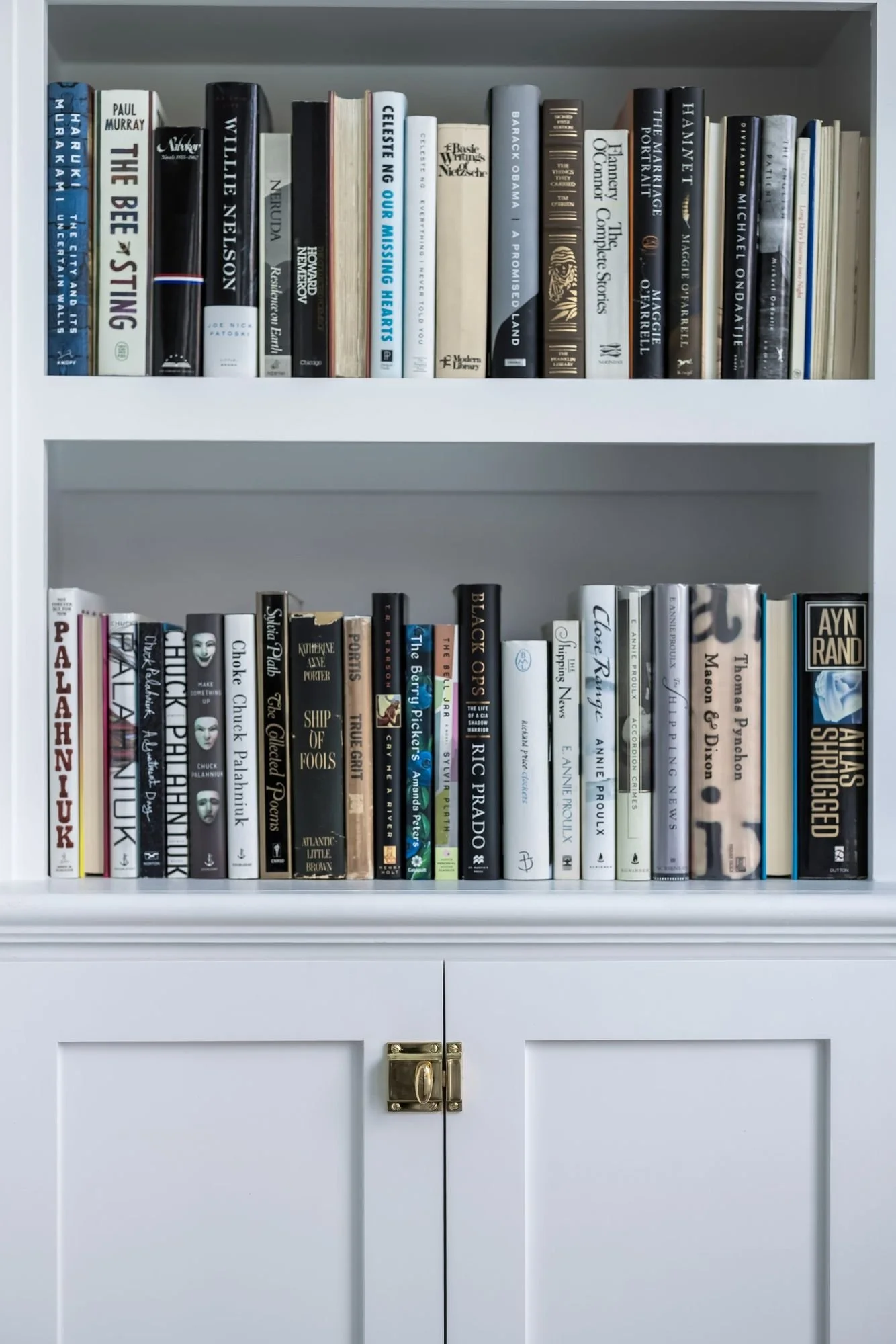Styled bookshelf detail with brass hardware