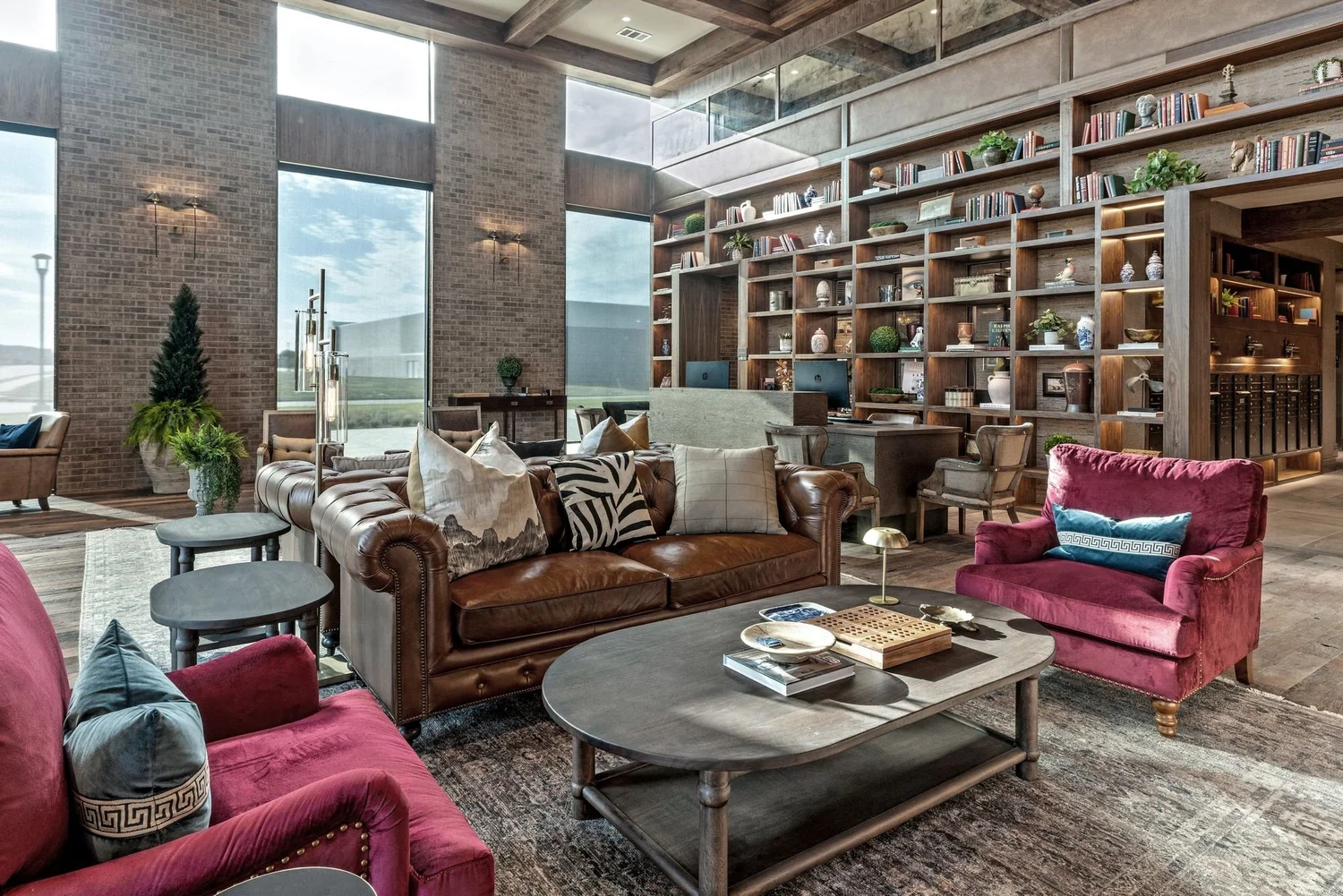 Clubhouse lounge with leather sofas and red velvet chairs