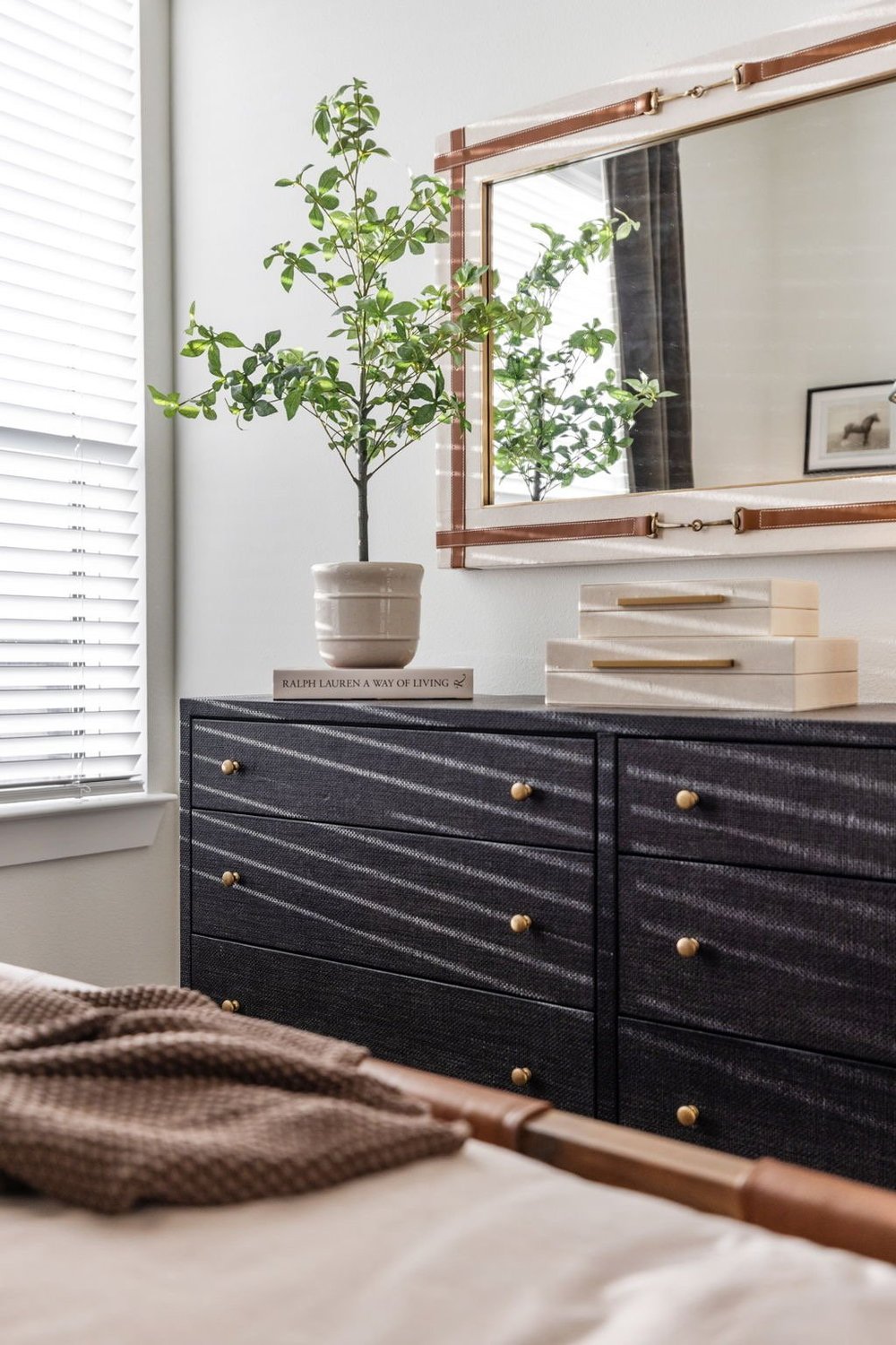 Bedroom with black dresser and potted plant
