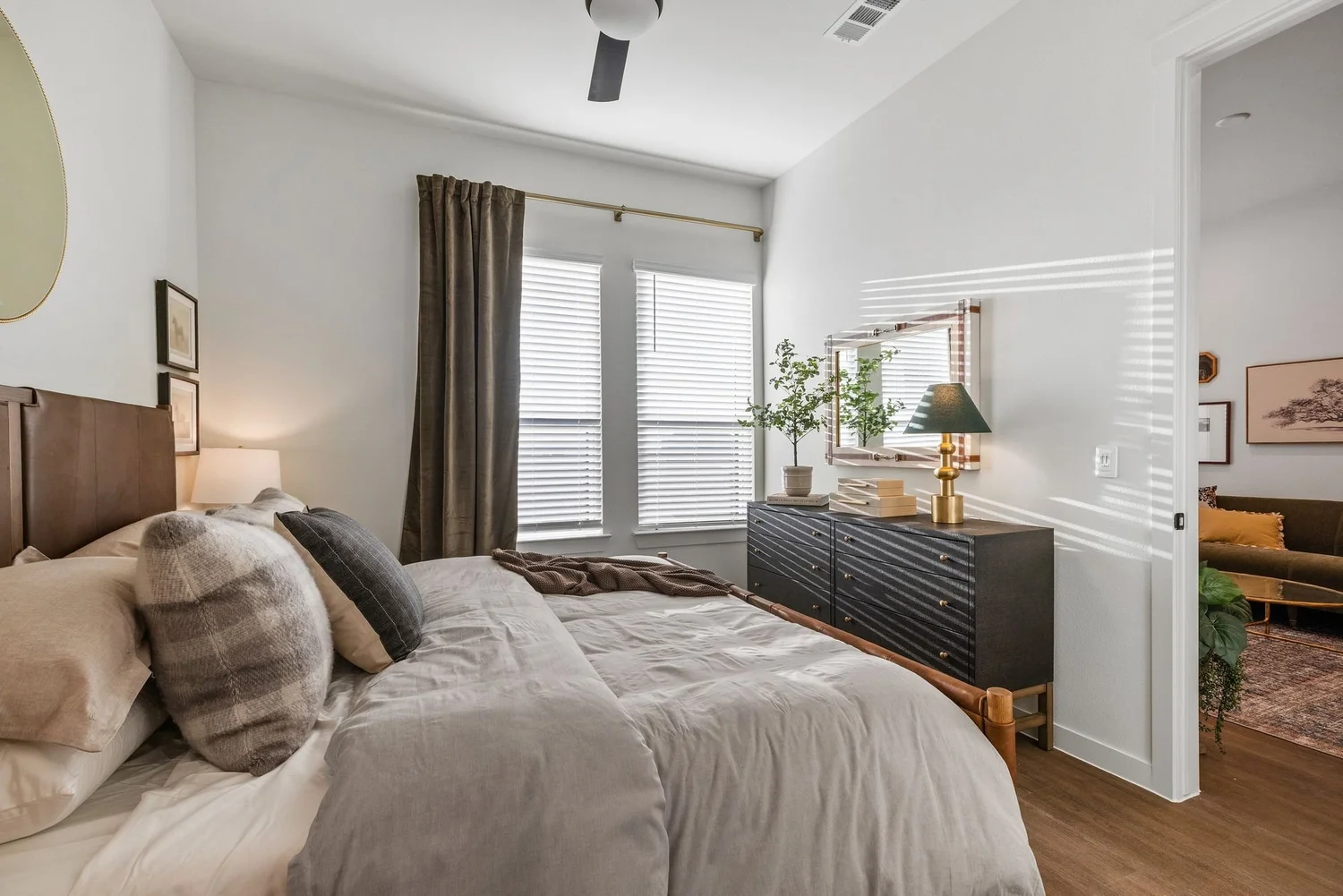 Model unit bedroom with layered neutral bedding