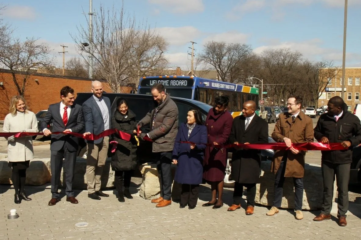 Ribbon cutting in front of Milwaukee bus