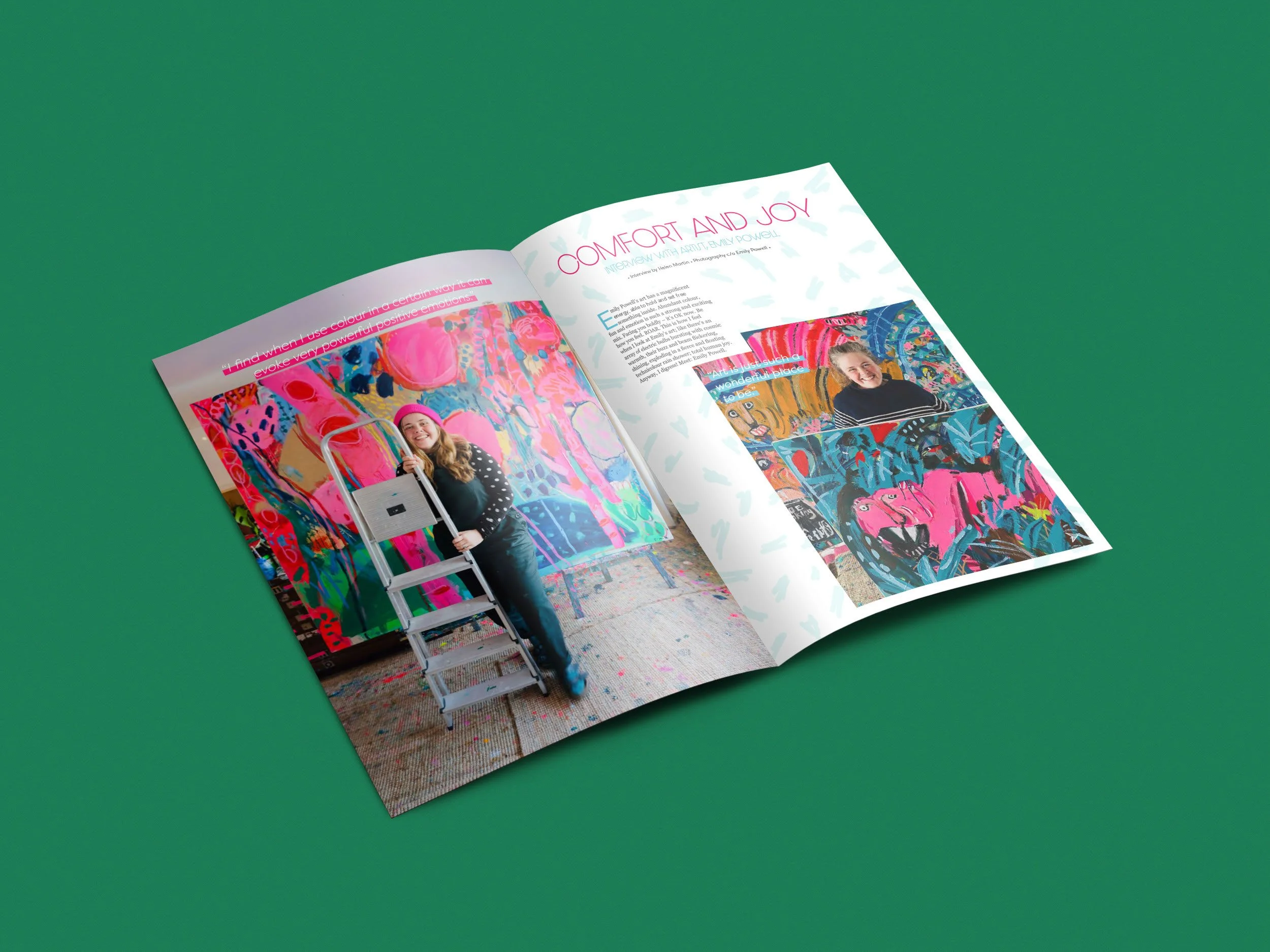 Open copy of Lionheart magazine featuring an interview with artist Emily Powell, showcasing colorful artwork and a smiling woman holding a ladder, on a green background.