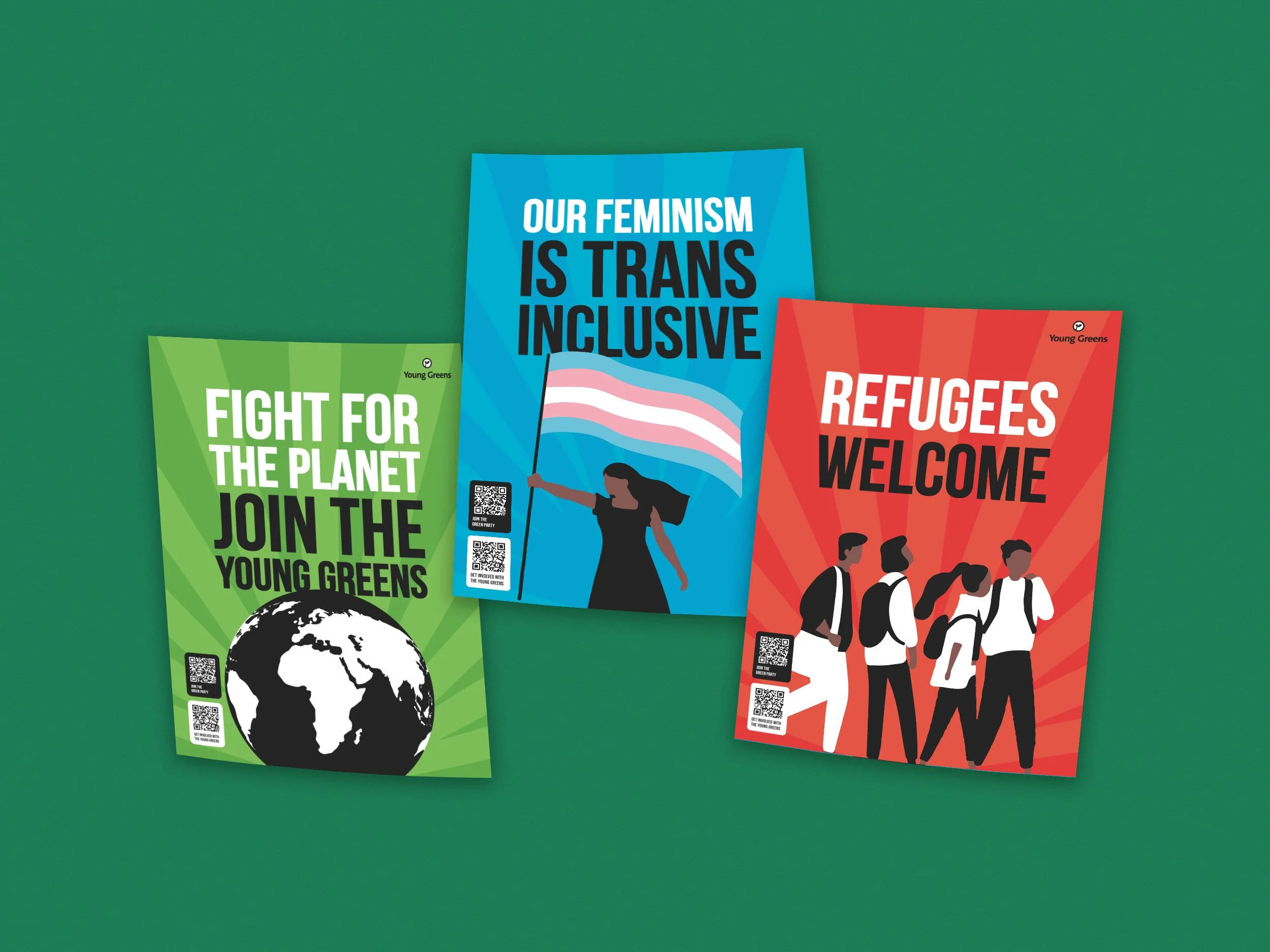 Colorful posters for The Young Greens with messages such as "Our Feminism is Trans Inclusive," "Fight for the Planet," and "Refugees Welcome," spread out on a green surface.