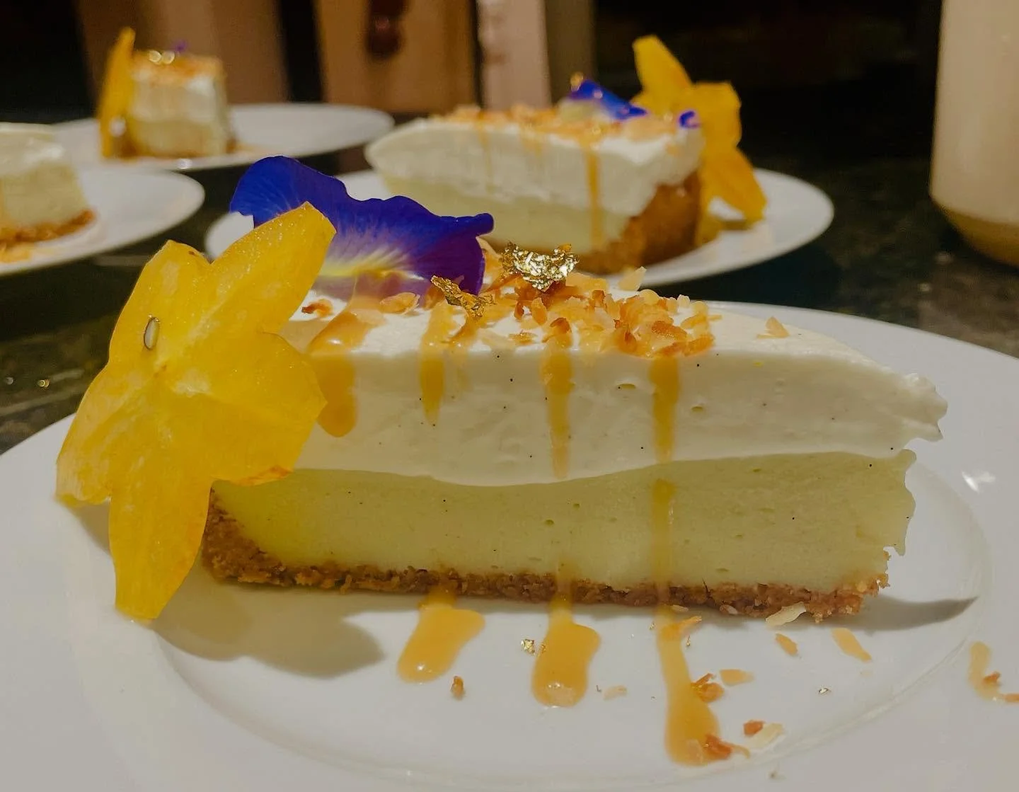 Coconut Cream Pie – Maui Style
This luxurious coconut cream pie features a toasted macadamia nut and graham cracker crust, filled with silky coconut custard. It’s finished with golden toasted coconut, a drizzle of house-made salted carame