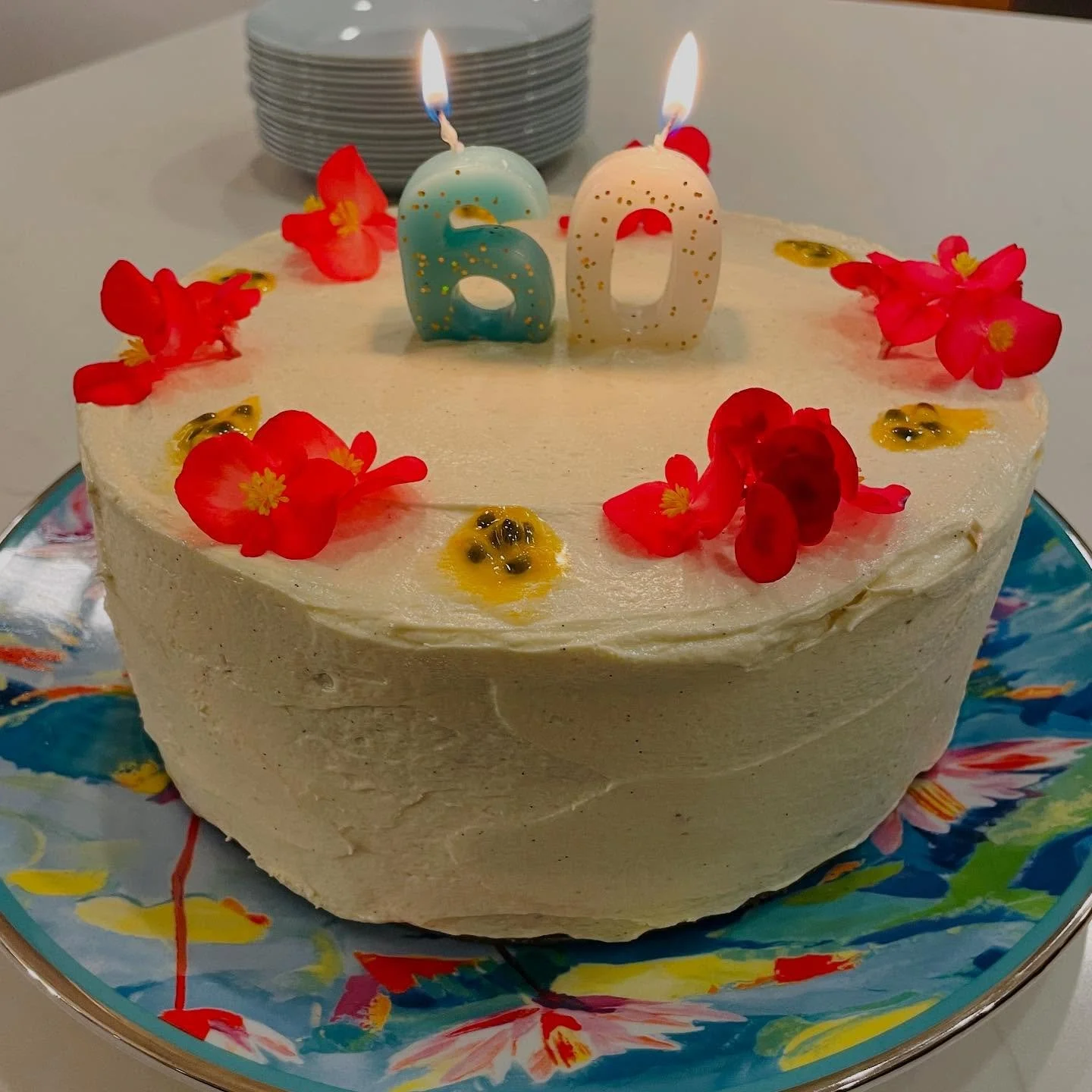 Celebrate with island flavor! This moist vanilla birthday cake is layered and frosted with a smooth vanilla bean cream, passion fruit curd, then finished with fresh passionfruit pulp and vibrant edible flowers for a tropical touch. A show-stopping de