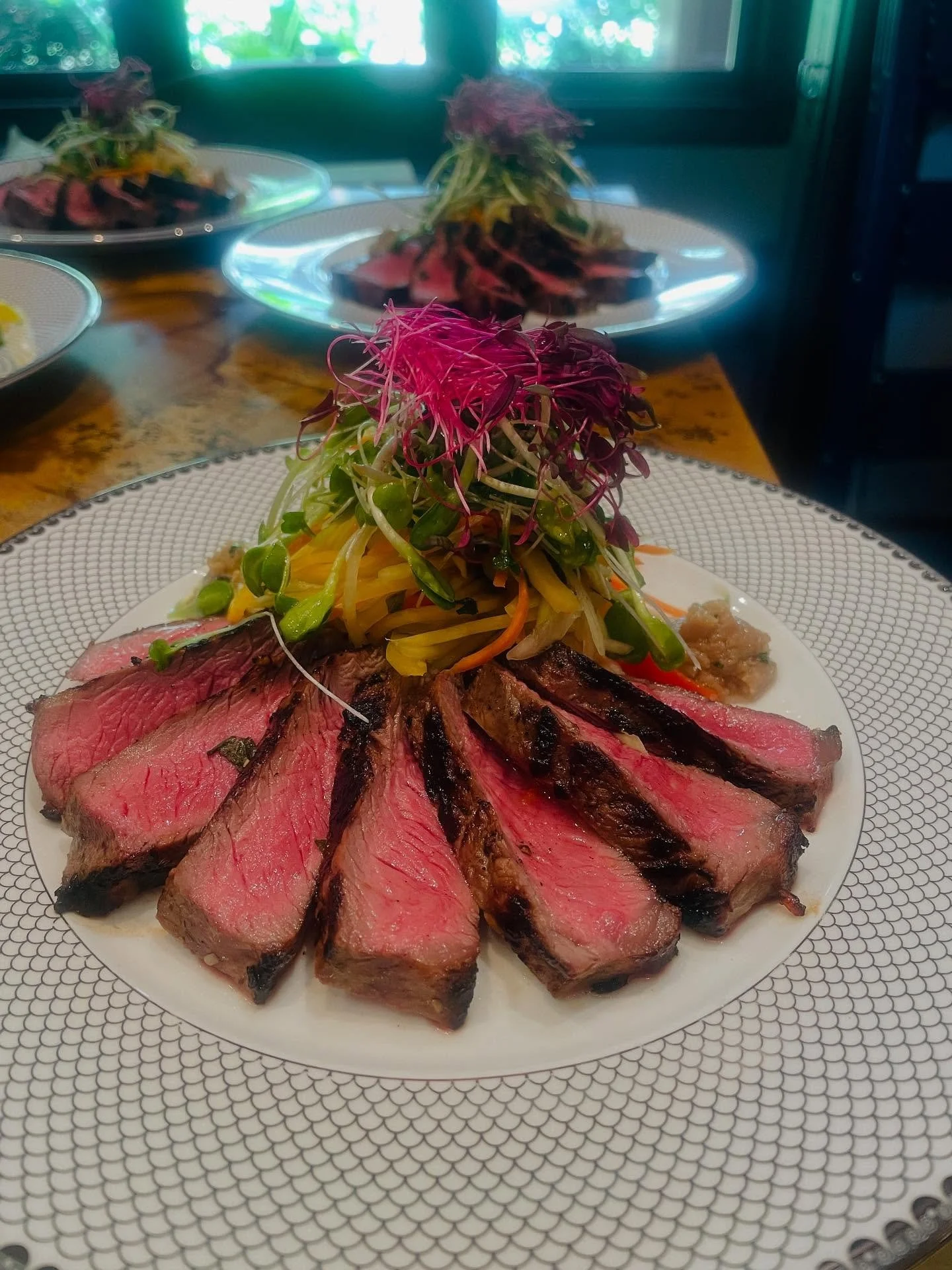 Looking for a bold and flavorful Maui dining experience? This New York Steak Salad features perfectly grilled, tender steak slices paired with a vibrant and spicy green papaya salad, topped with fresh island microgreens. It’s a fusion of tropic