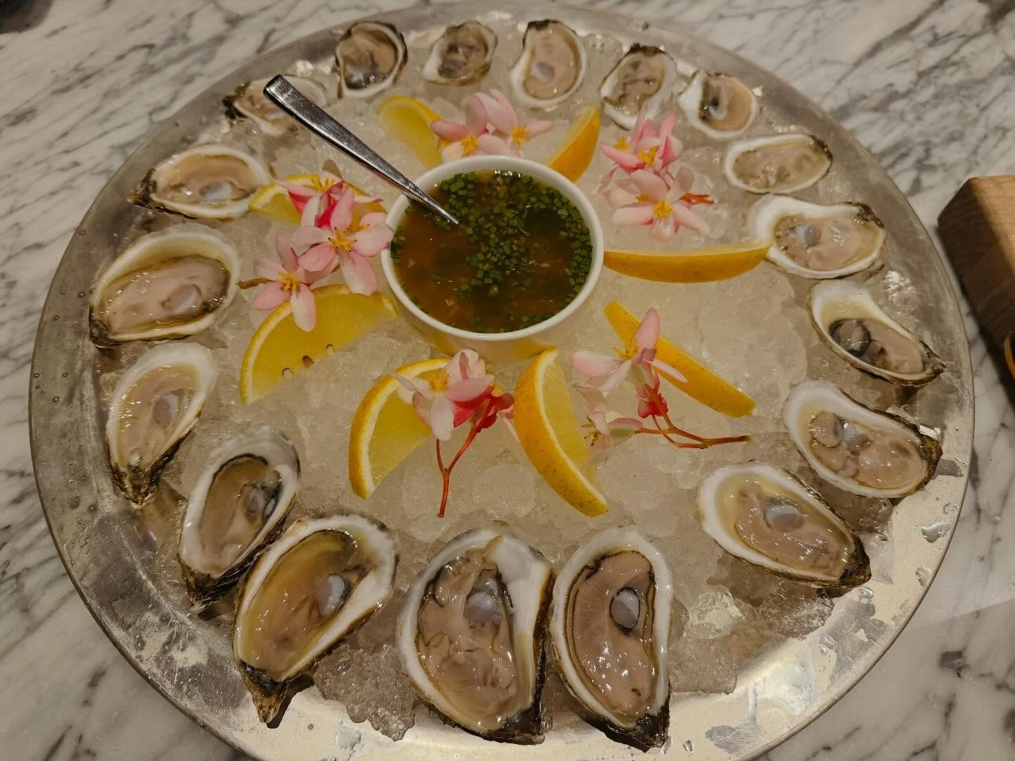Chebooktook oysters, freshly shucked and served over ice 🌊
Briny, clean, and kissed with citrus&mdash;finished with a bright mignonette and edible blossoms for a little island elegance. Simple, pristine, and all about letting the oysters shine.

#oy