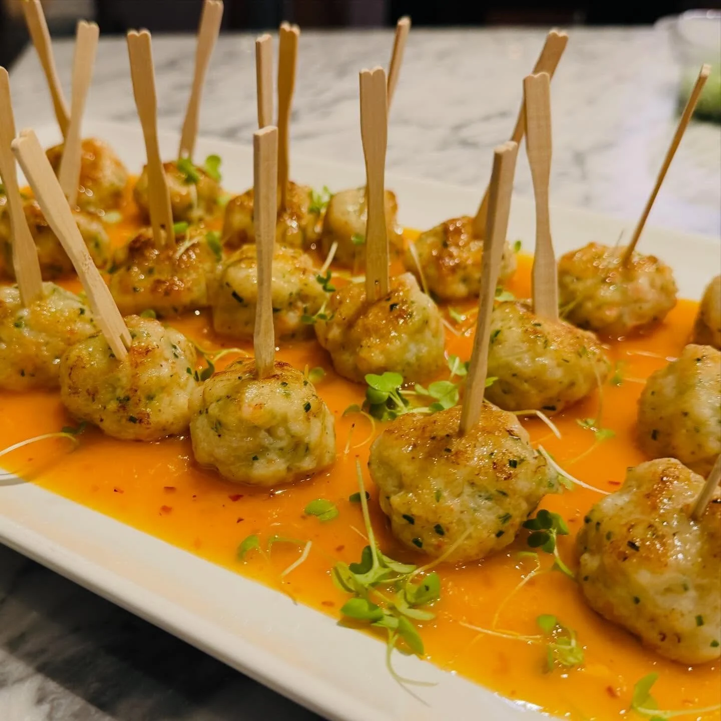 Leo&rsquo;s famous shrimp balls are crispy on the outside, tender and juicy within&mdash;packed with sweet shrimp, fresh herbs, and subtle aromatics. Served warm and finished with a vibrant, lightly spicy sauce, they&rsquo;re the kind of bite-sized i