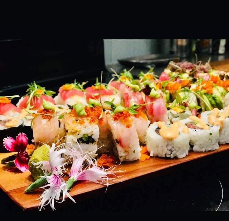 Assorted sushi platter with fresh fish and artful presentation.