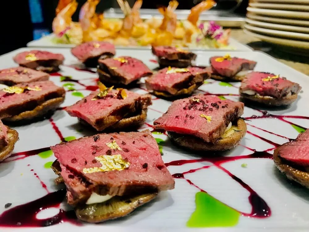 Lamb bite with shiitake mushroom and savory glaze.