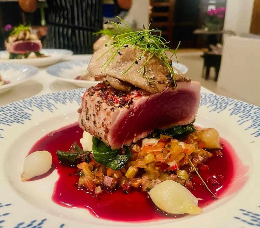 Seared peppercorn tuna with a crisp crust and tender center.