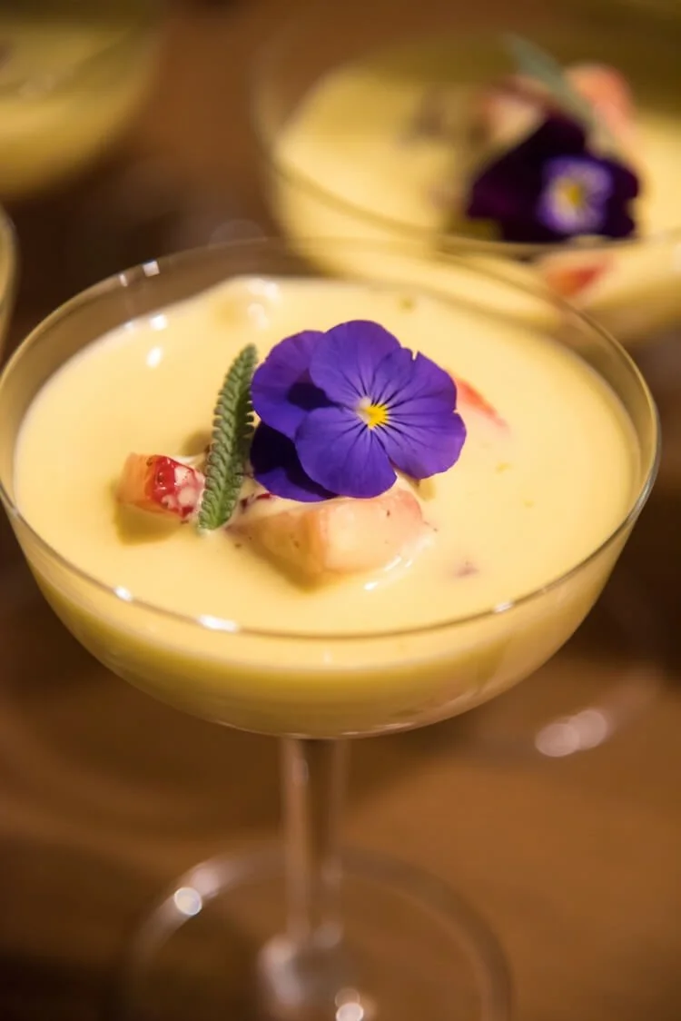 Italian sabayon in a champagne glass with edible flowers.