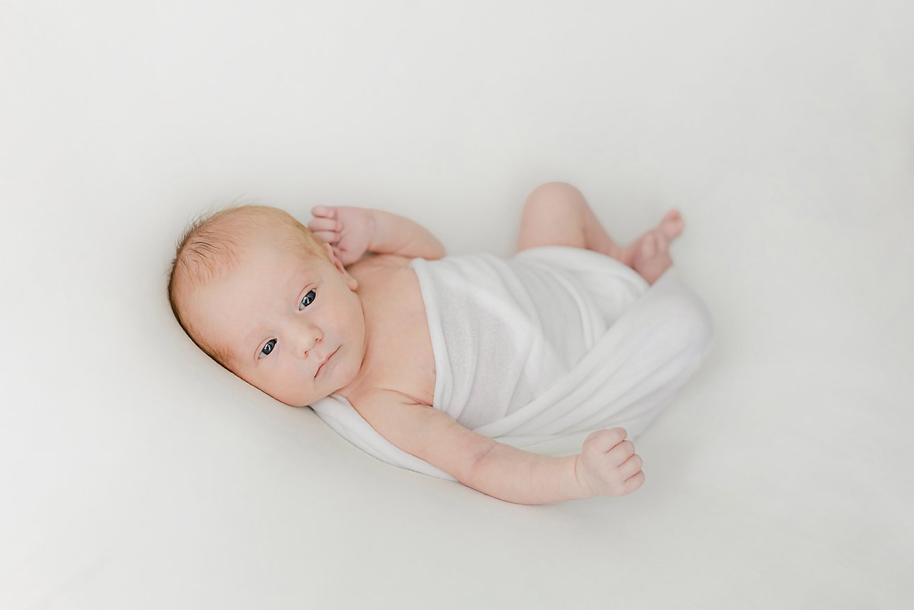 sweet newborn baby boy with his eyes open