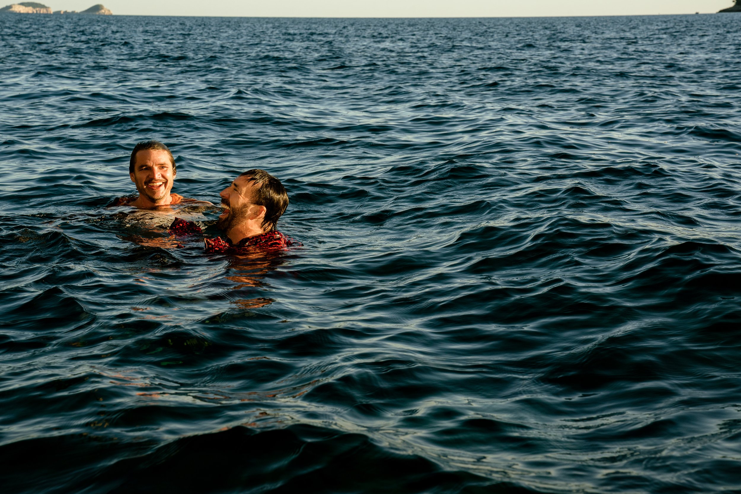 Pedro Pascal as 'Javi Gutierrez' (left) and Nicolas Cage as 'Nicolas Cage' celebrate their successful jump off the beautiful Mallorca cliffs. Photo Credit: Katalin Vermes/Lionsgate