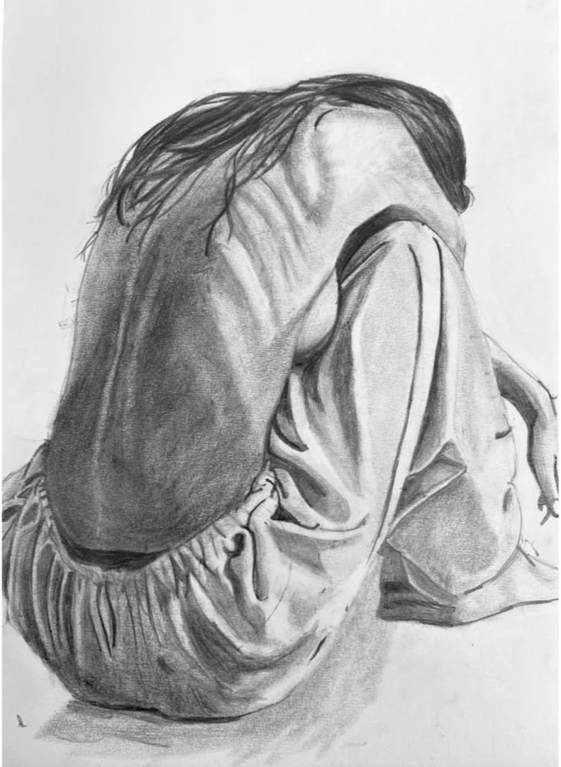 A detailed black and white pencil drawing of a person with medium-length hair, positioned with their face hidden by their arms and hands, appearing to be in a contemplative or emotional state.