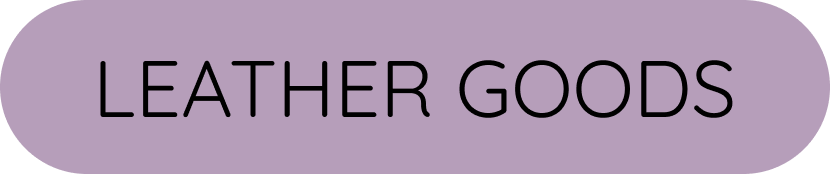 Sign reading 'Leather Goods' with purple background and black text.